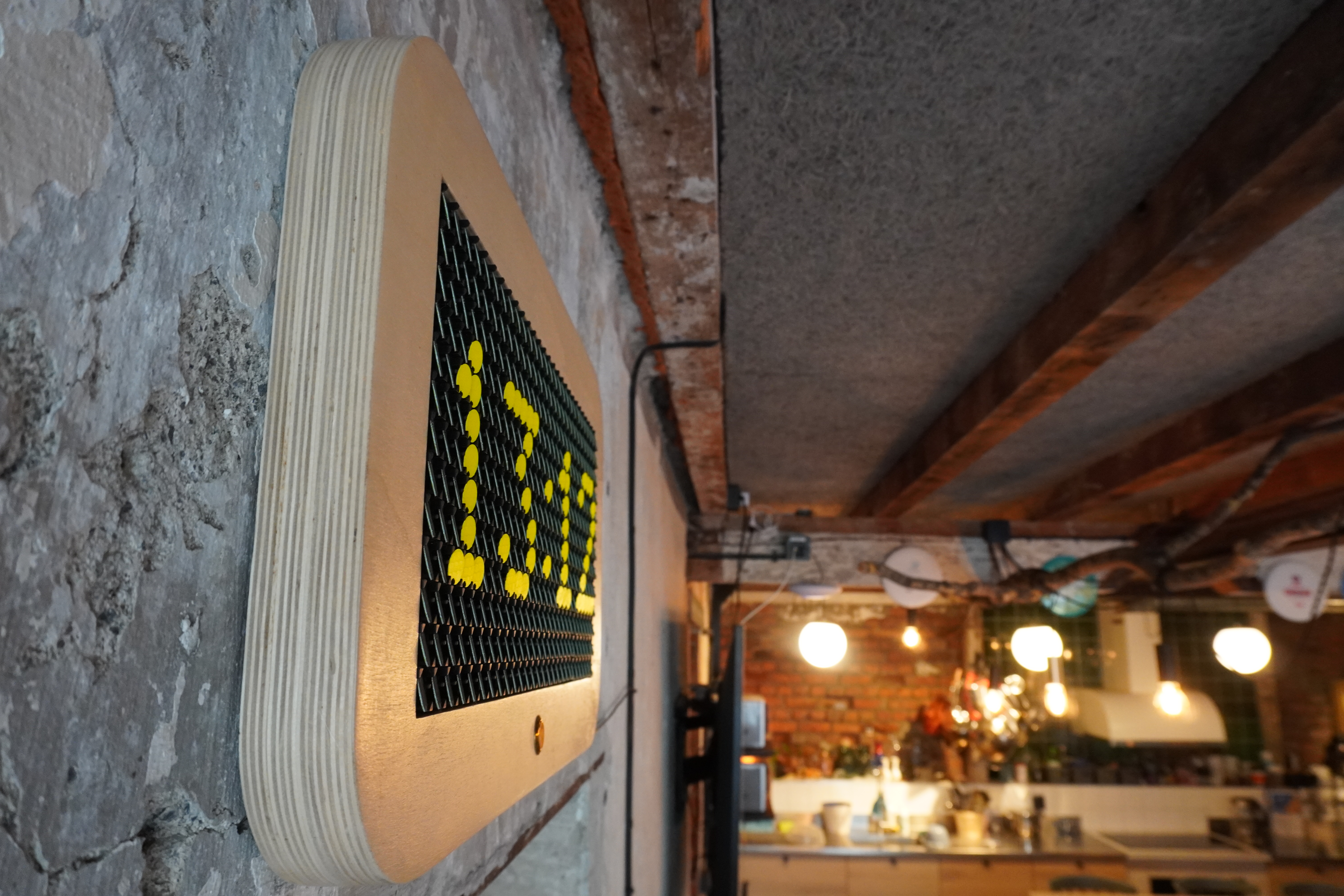 Side view of the mounted clock showing stacked plywood edges