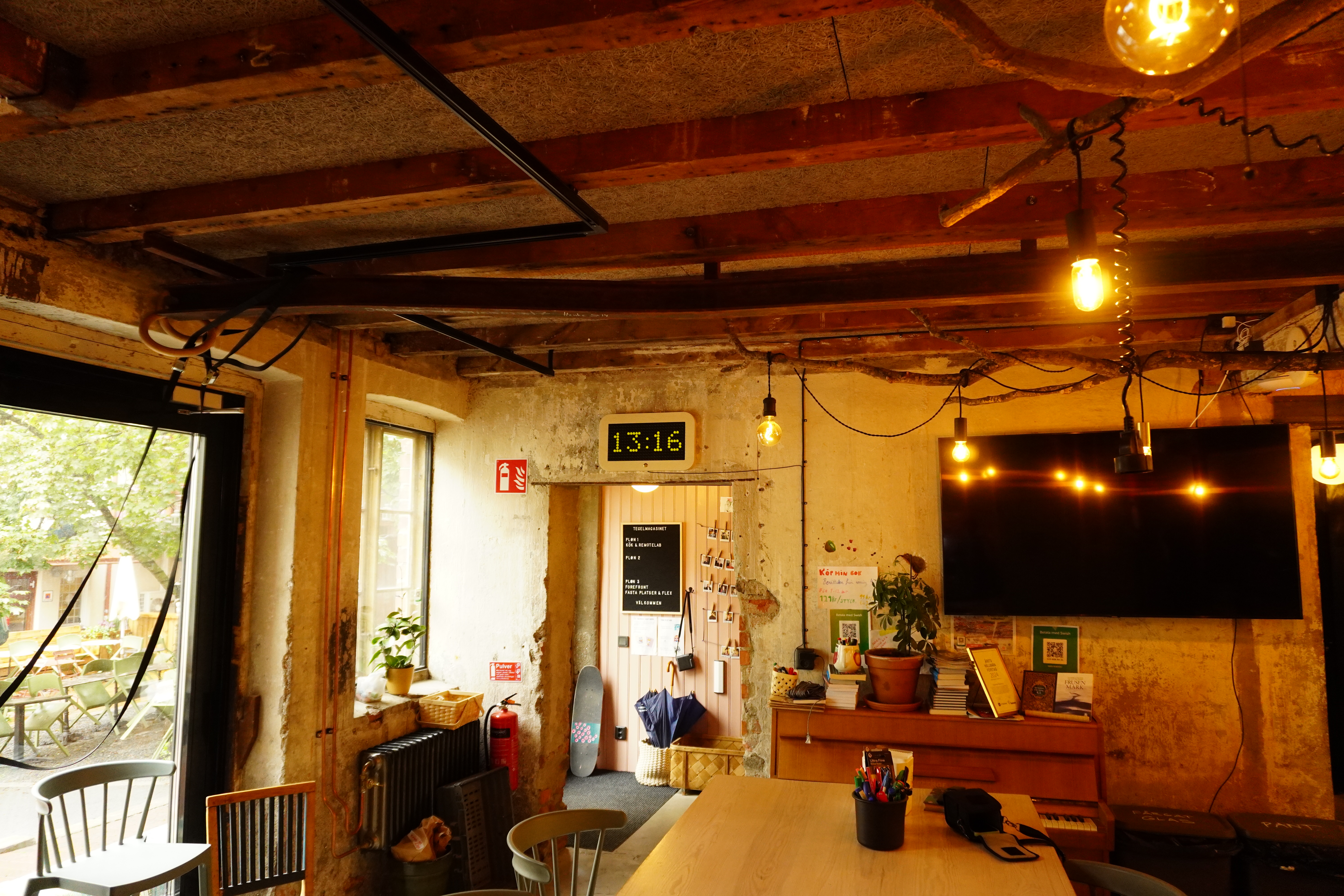 Wide view of the room with the flip-dot clock above the door