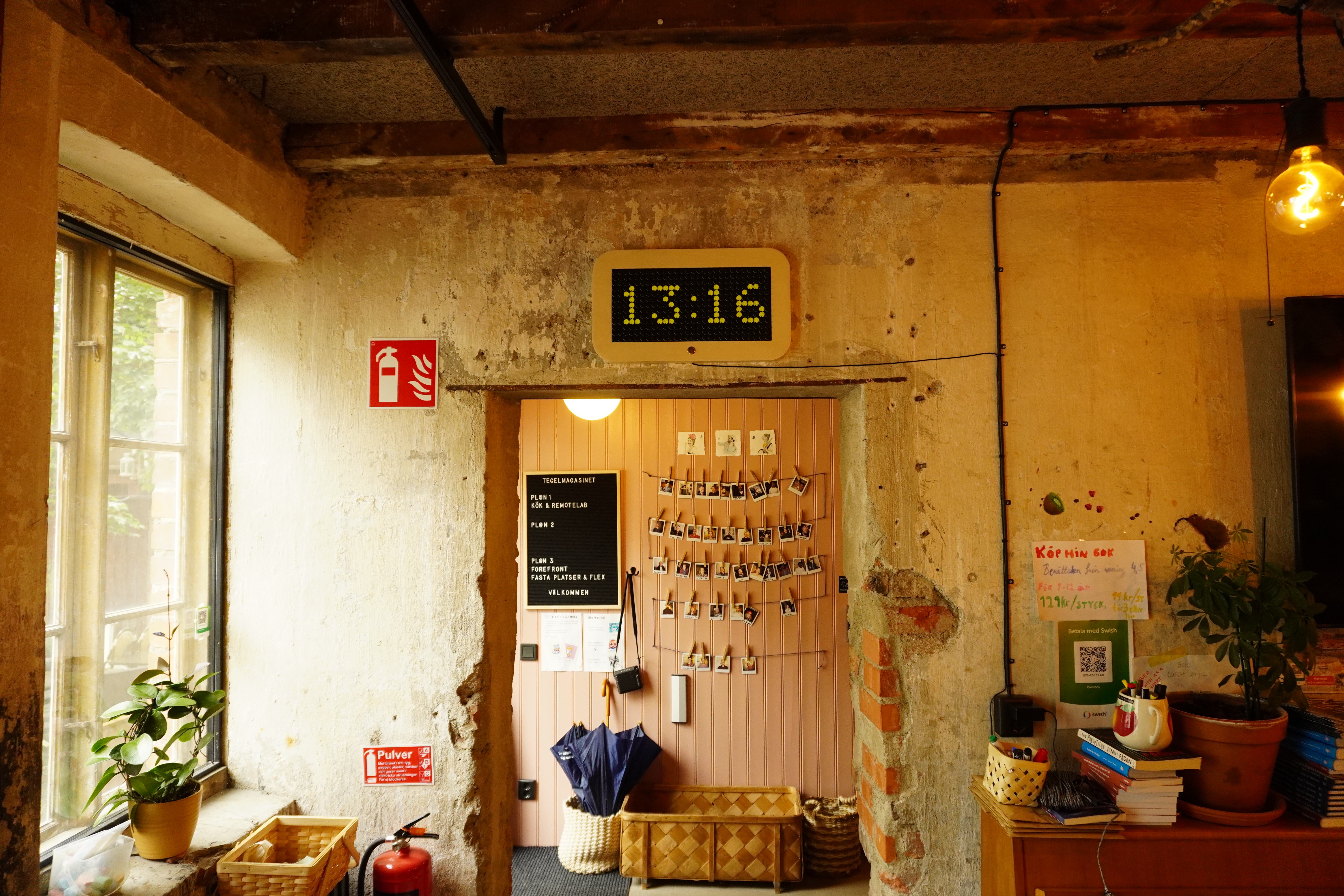 Flip-dot wall clock mounted above a doorway in a rustic interior